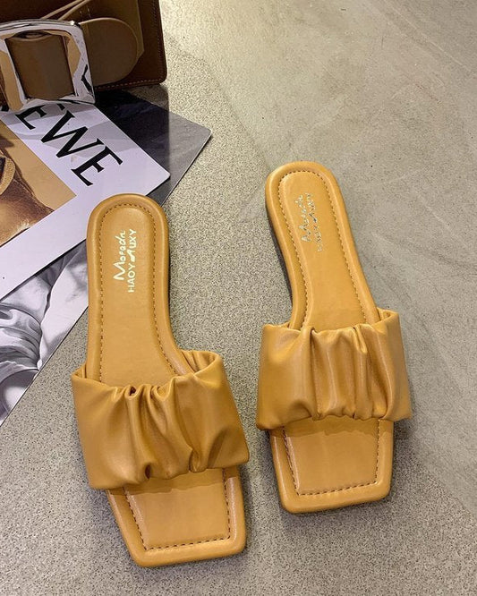Sandales plates en cuir verni plié